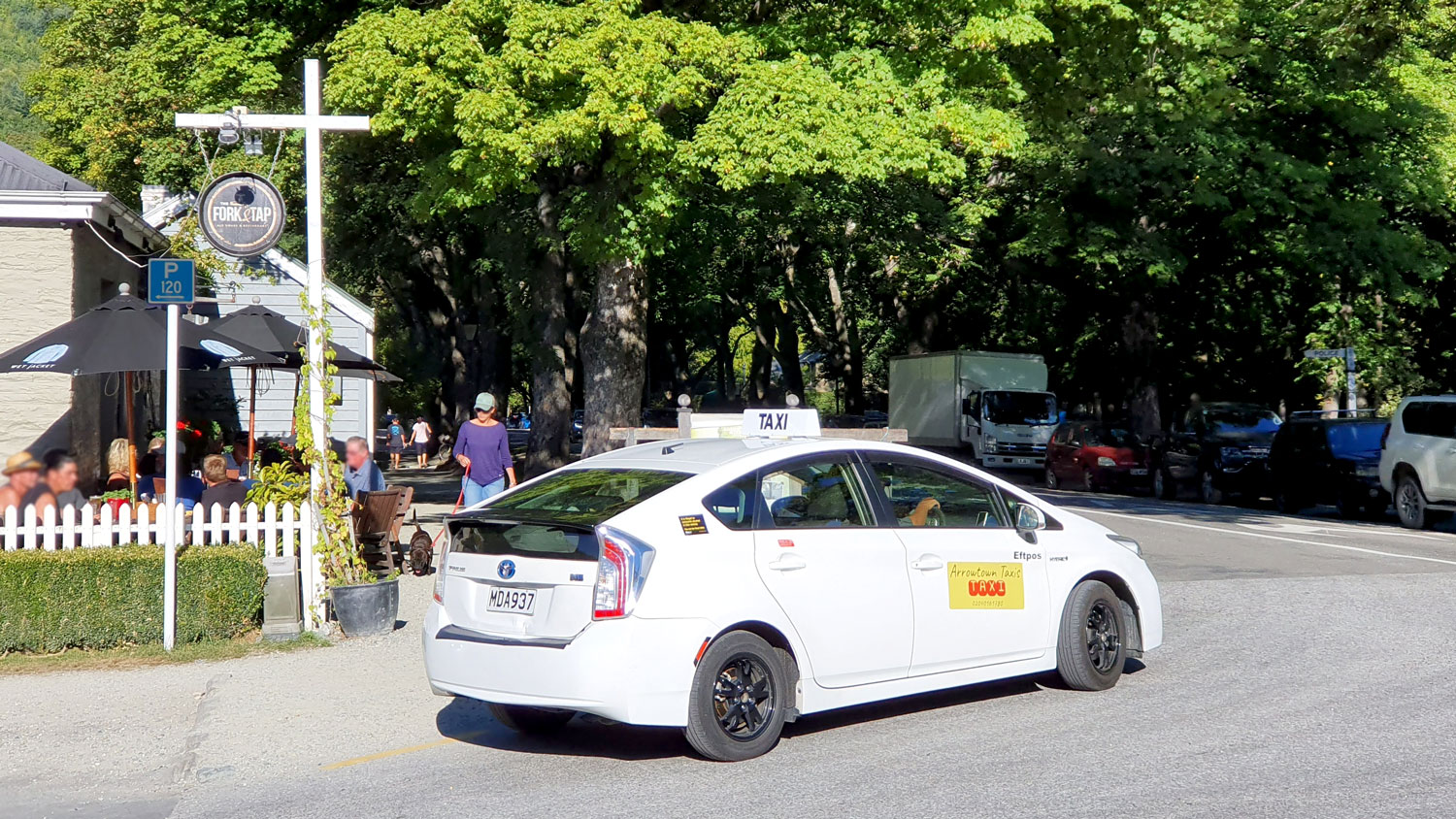 One of the Arrowtown Taxi electric cars outside the Fork and Tap Restaurant in Arrowtown.